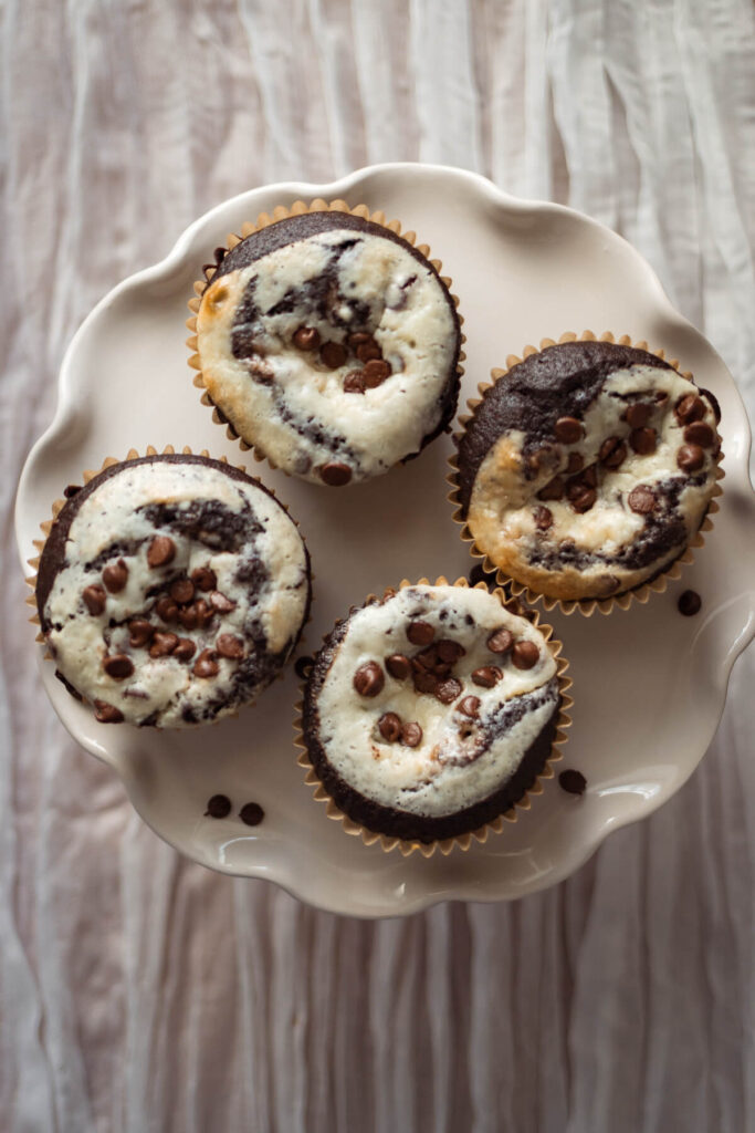 close up view of four gluten free black bottom cupcakes