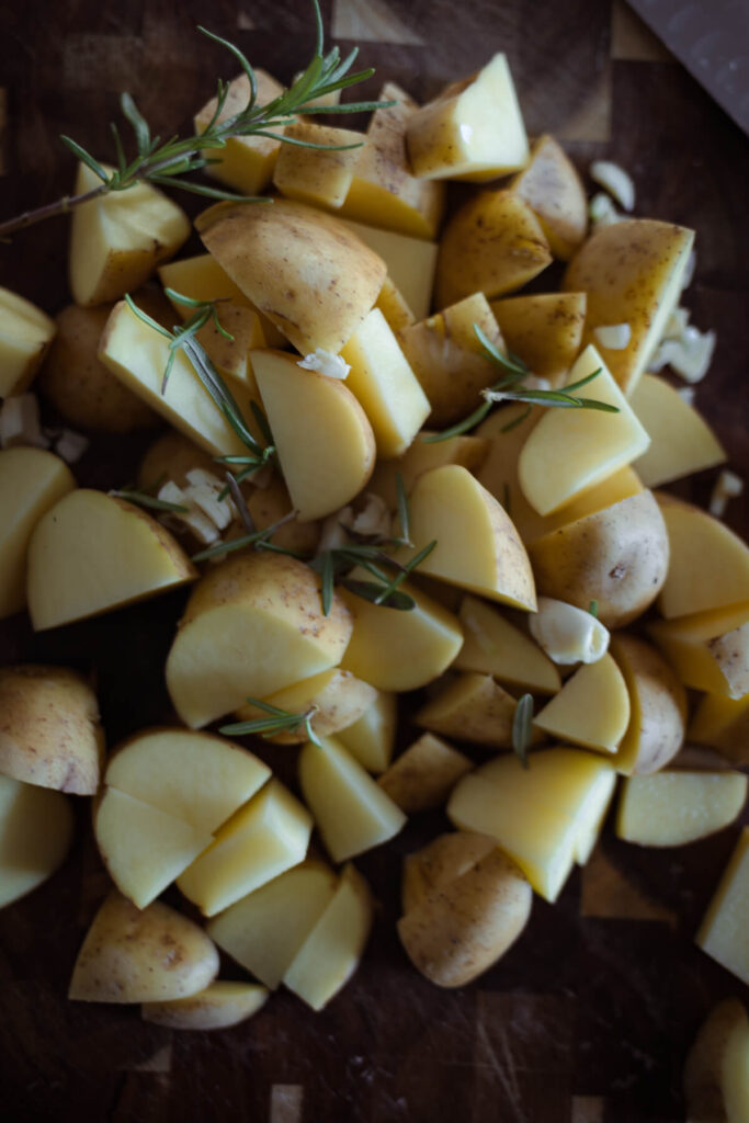 cut up potatoes with garlic and rosemary