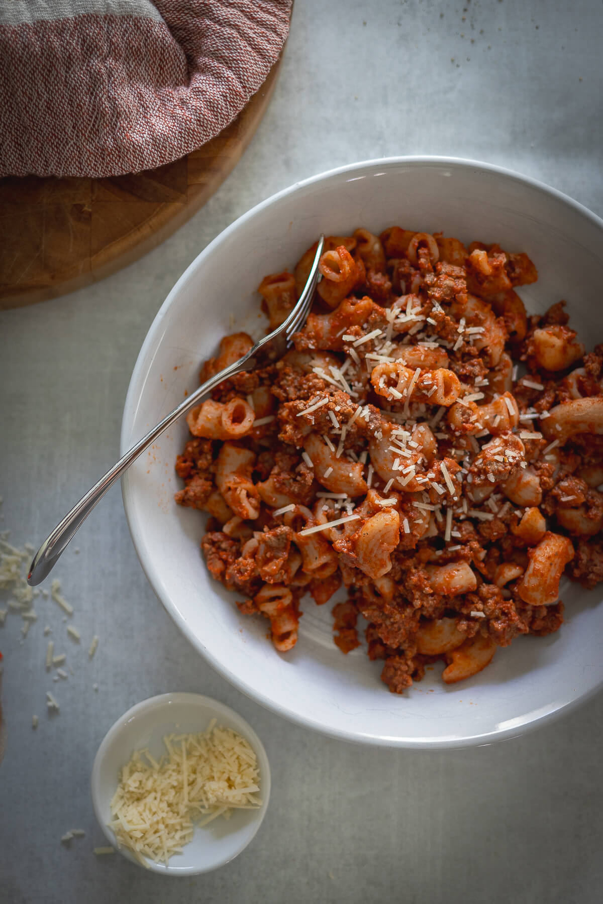 beefaroni with gluten free pasta in a bowl with parmesan cheese