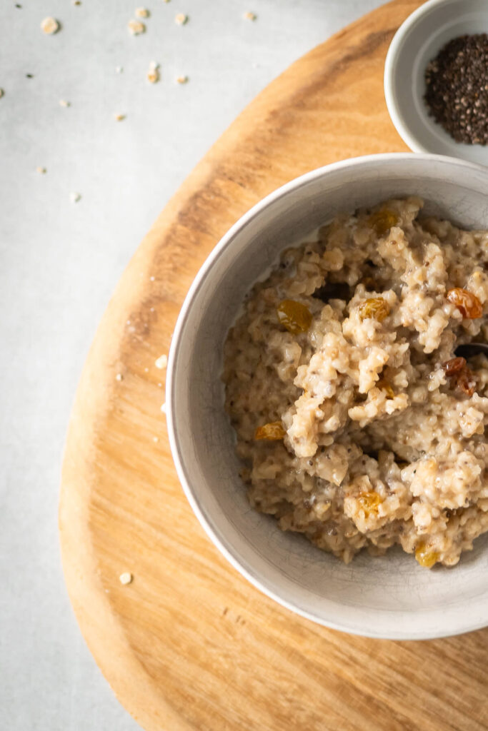 close up of creamy brown sugar oatmeal with chia seeds and raisins