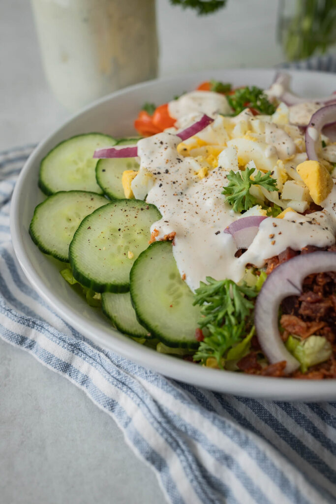 close up of a house salad with ranch dressing