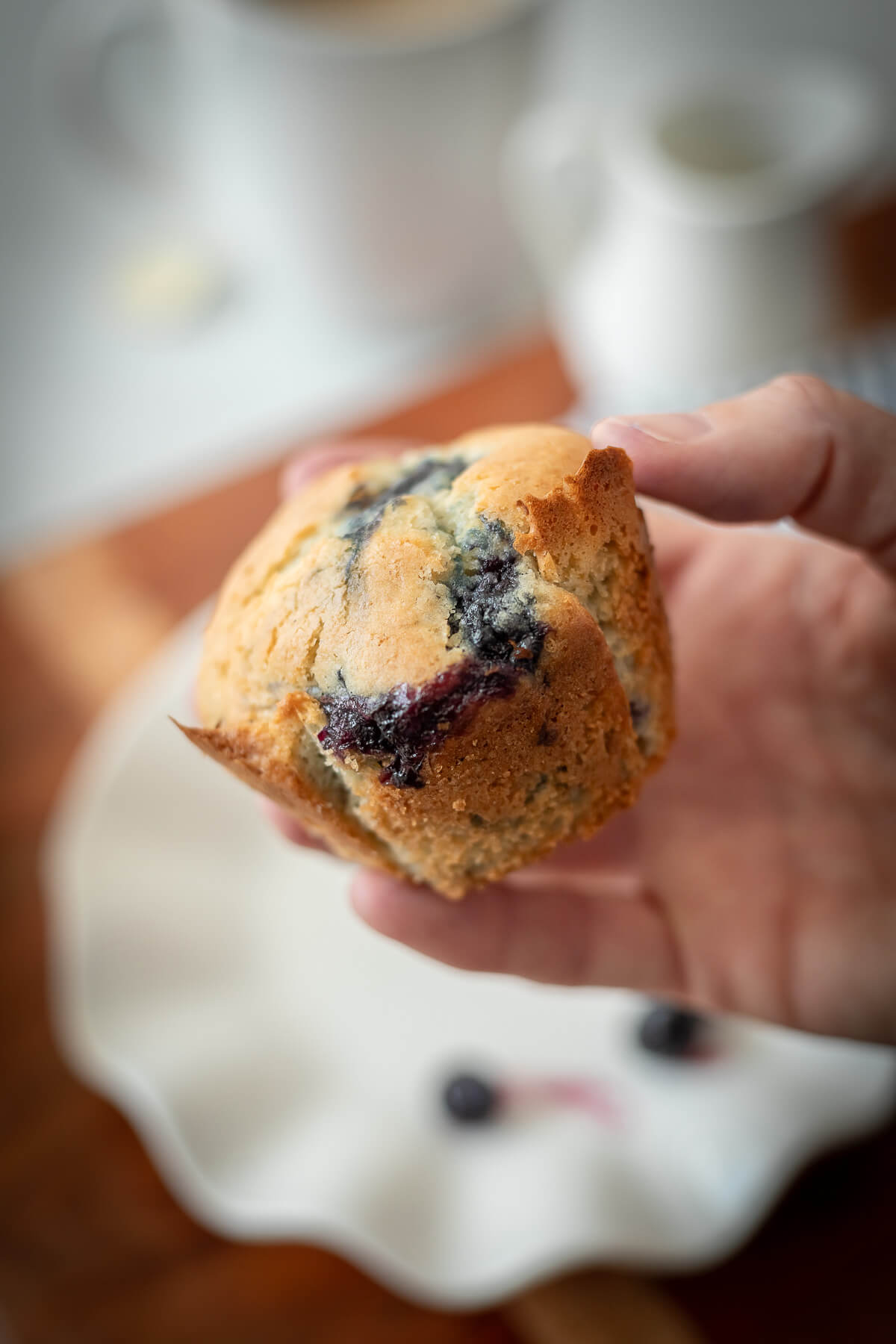 holding a gluten free blueberry muffins