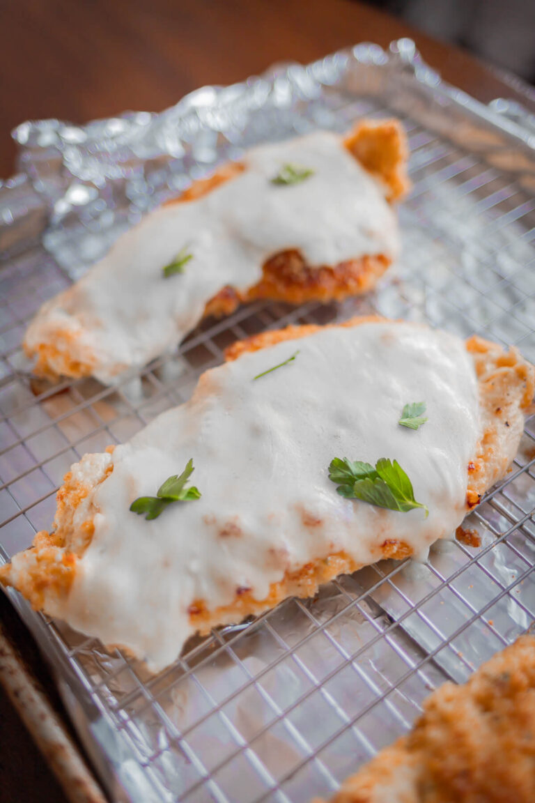 view of gluten free breaded chicken with cheese and parsley on top