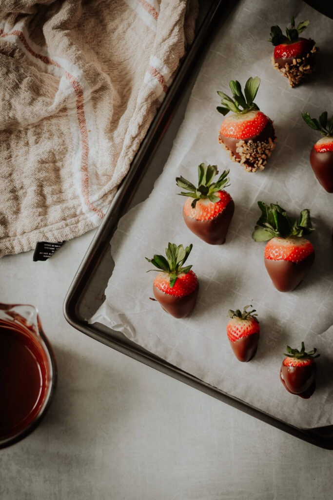 chocolate covered strawberries on a sheet tray