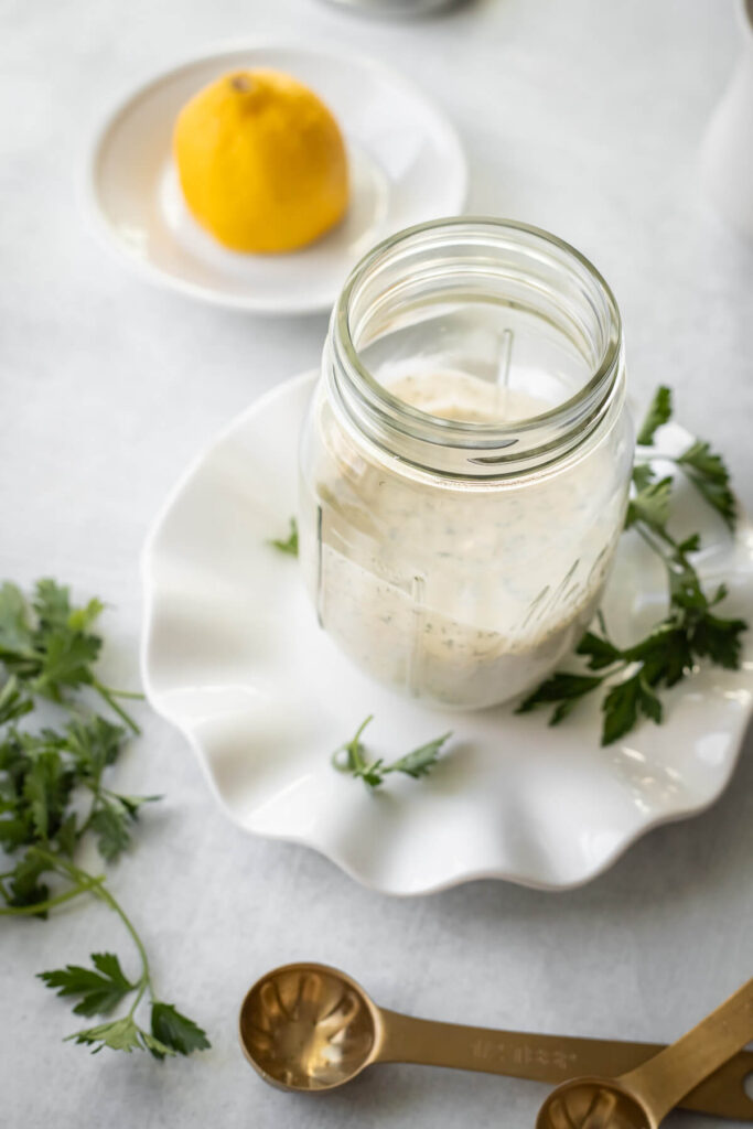 homemade ranch dressing in a mason jar on a plate